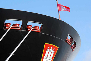 2120 011_15820 Seil und Schiffsbug des Containerschiffs "Hanover" am Hamburger Container Terminal Altenwerder; über dem Hamburg Wappen flattert die Hamburg Fahne im Wind.